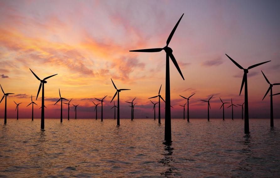 Offshore Wind Turbines Farm At sunset